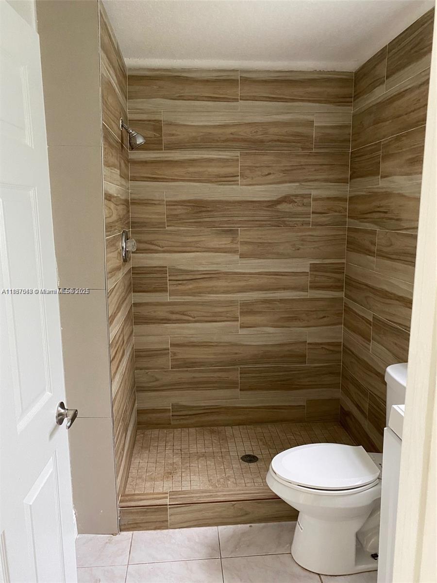 26 Crossings Circle, Unit B Boynton Beach, FL 33435 - Photo 5 of 15 a bathroom with a toilet and a shower