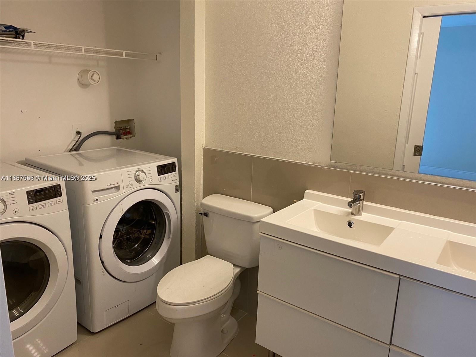 26 Crossings Circle, Unit B Boynton Beach, FL 33435 - Photo 10 of 15 a bathroom with a sink and a washer dryer