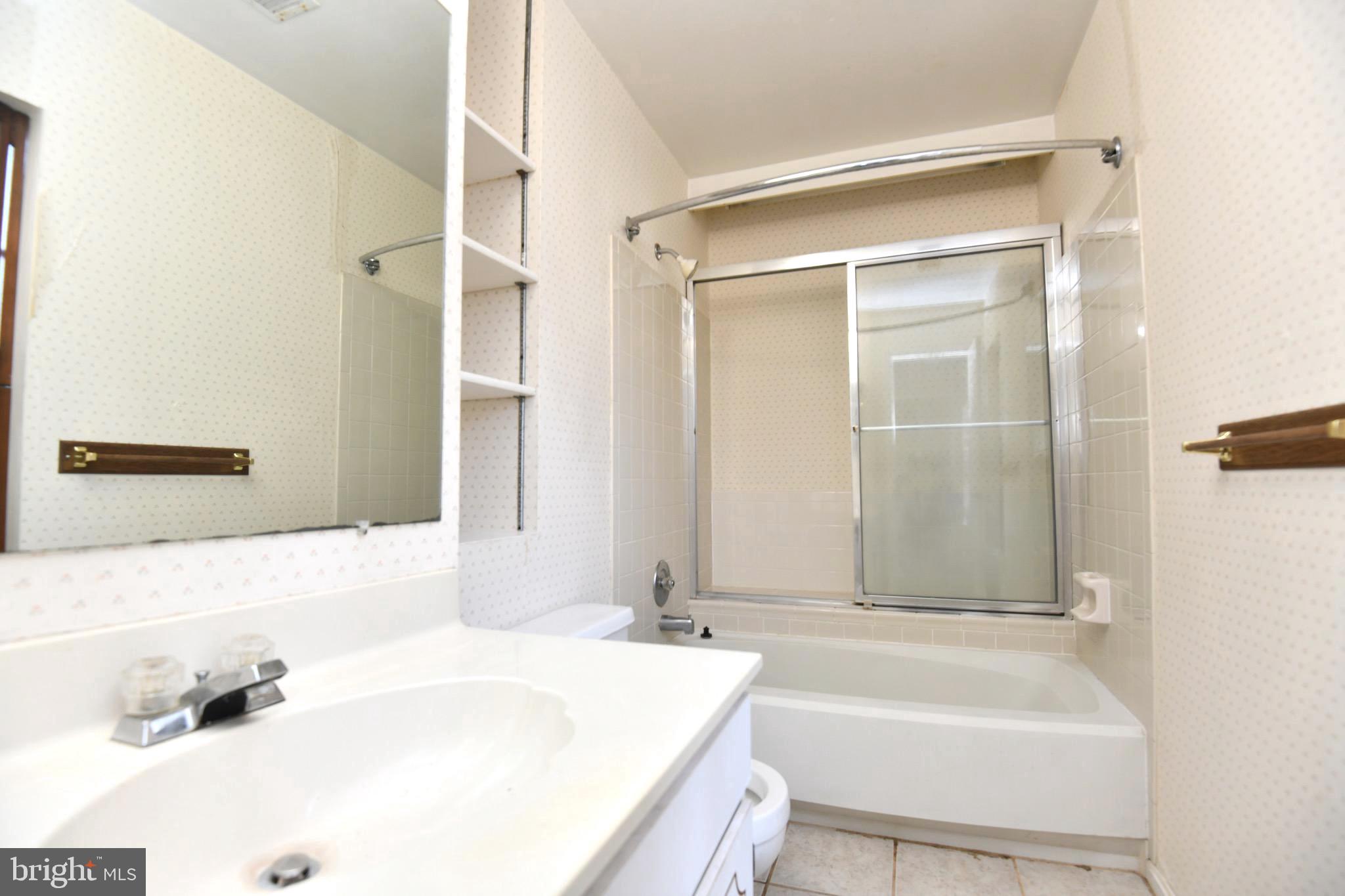 1052 Jeff Ryan Drive Herndon, VA 20170 - Photo 13 of 13 a bathroom with a tub a sink and a large mirror