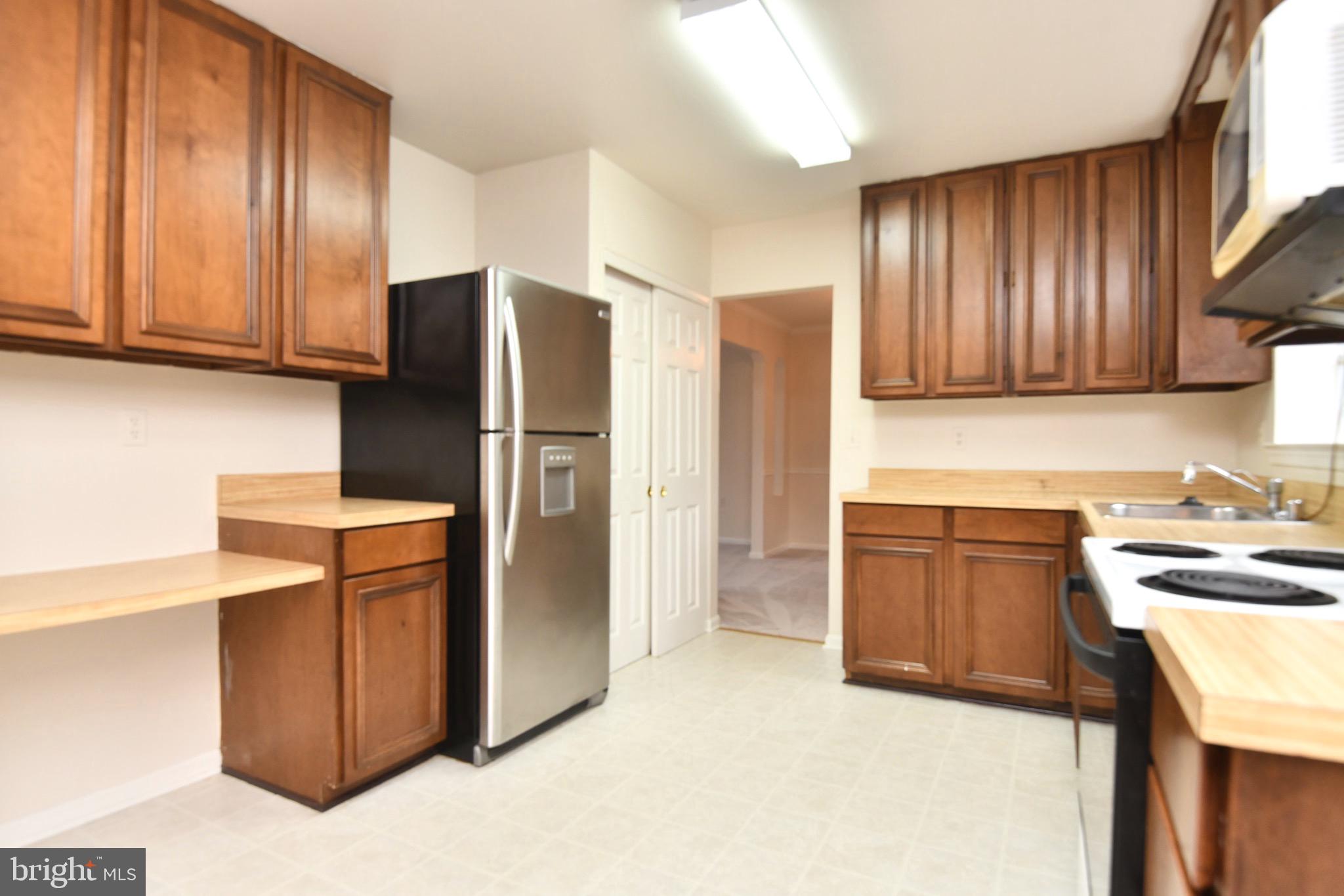 1052 Jeff Ryan Drive Herndon, VA 20170 - Photo 7 of 13 a kitchen with stainless steel appliances granite countertop a refrigerator stove and sink