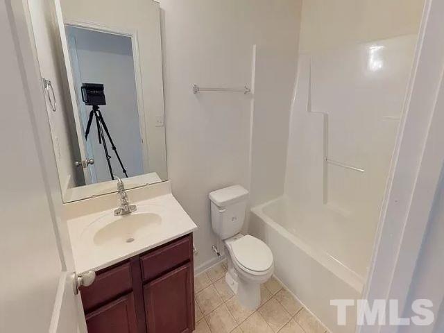 2800 Smooth Stone Trail Raleigh, NC 27610 - Photo 13 of 16 a bathroom with a sink a toilet and shower