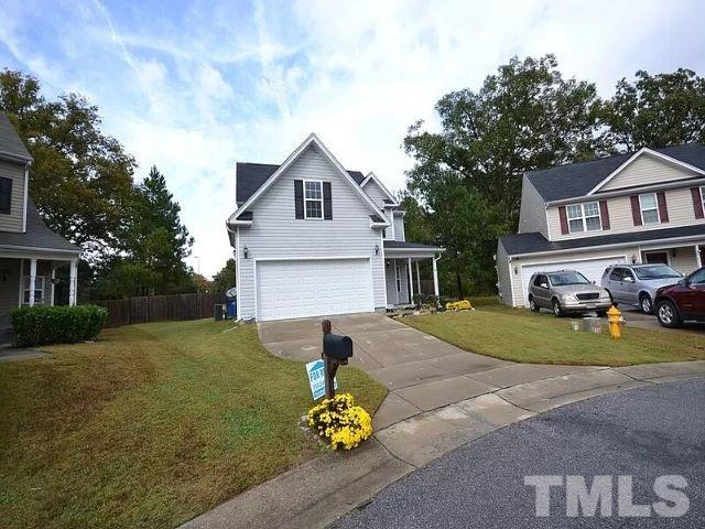 2800 Smooth Stone Trail Raleigh, NC 27610 - Photo 16 of 16 a front view of a house with a yard and garage