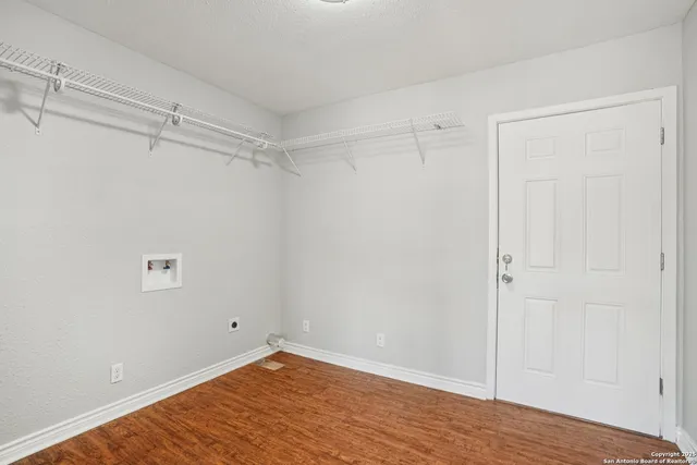 a view of a room with wooden floor