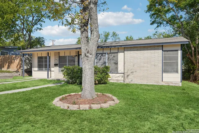 a front view of house with yard and green space