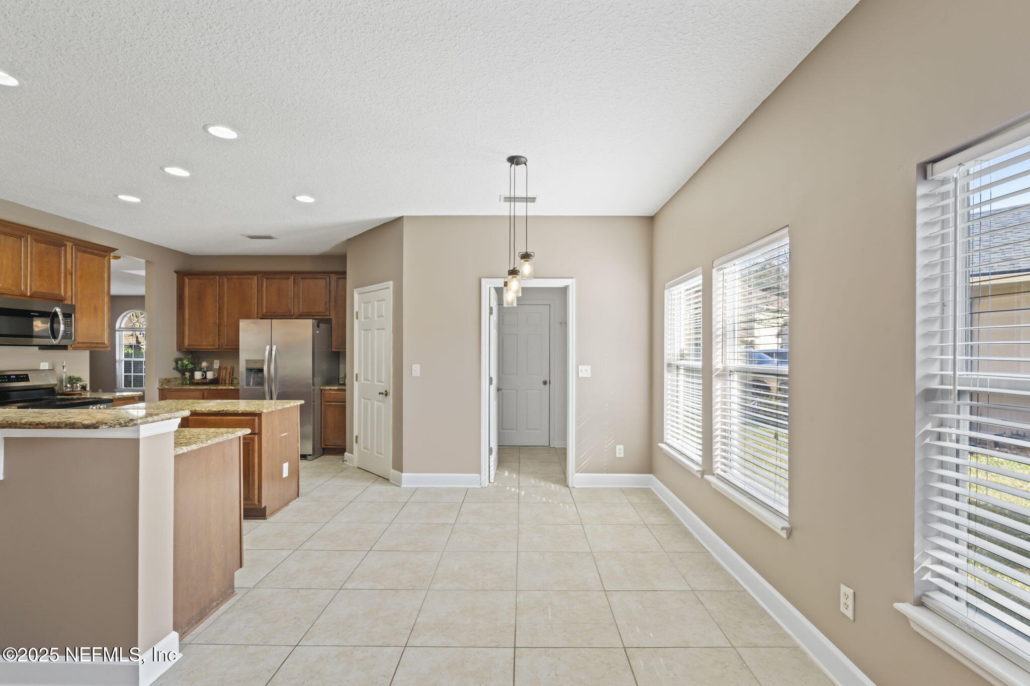 3370 Turkey Creek Drive Green Cove Springs, FL 32043 - Photo 19 of 44 a large kitchen with stainless steel appliances granite countertop a refrigerator and a sink