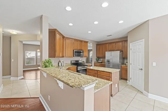 a kitchen with stainless steel appliances granite countertop a sink counter space cabinets and stainless steel appliances
