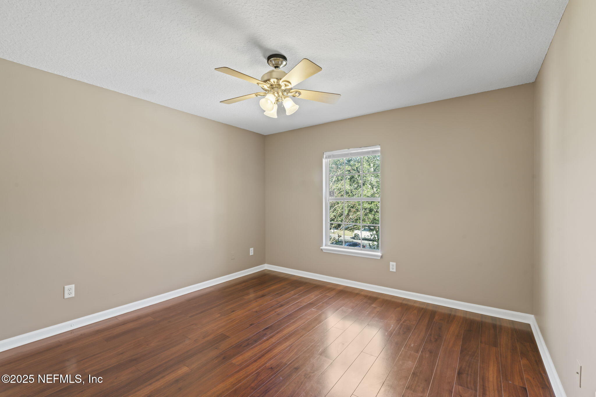 3370 Turkey Creek Drive Green Cove Springs, FL 32043 - Photo 27 of 44 an empty room with wooden floor chandelier fan and windows