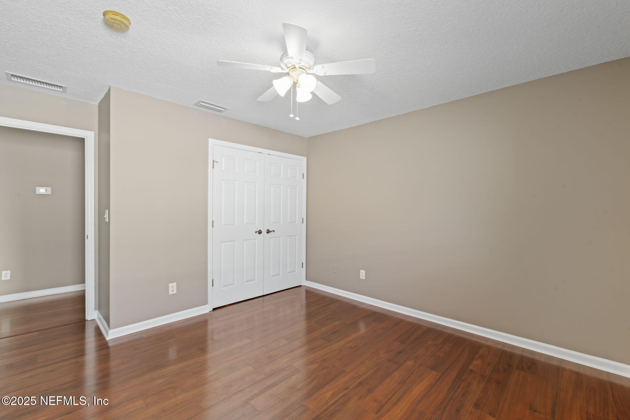 3370 Turkey Creek Drive Green Cove Springs, FL 32043 - Photo 29 of 44 an empty room with wooden floor and fan