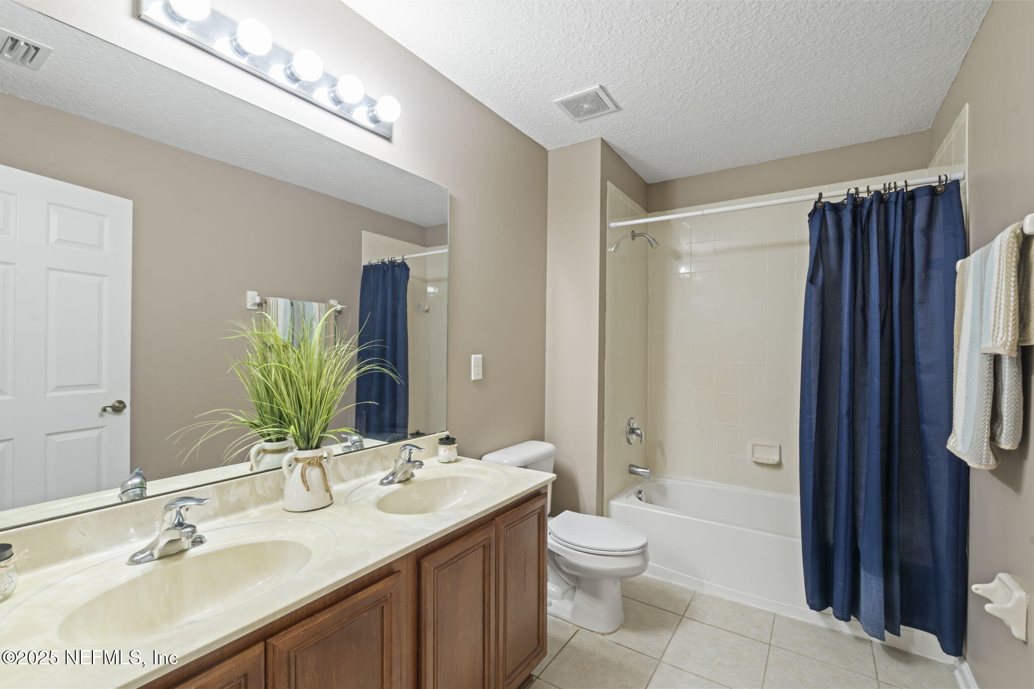 3370 Turkey Creek Drive Green Cove Springs, FL 32043 - Photo 32 of 44 a bathroom with a granite countertop sink a toilet a mirror and shower