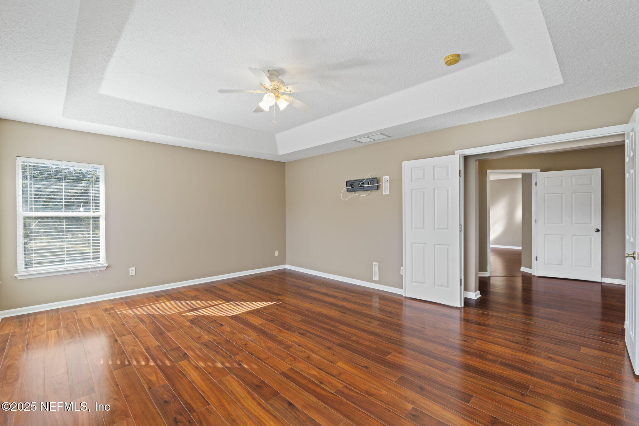 3370 Turkey Creek Drive Green Cove Springs, FL 32043 - Photo 34 of 44 an empty room with wooden floor chandelier and windows
