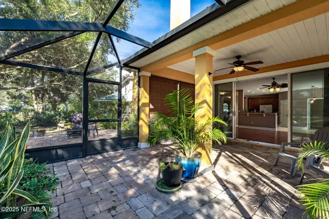 a view of a patio with table and chairs and potted plants