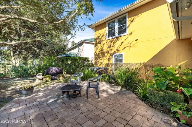 a backyard of a house with table and chairs