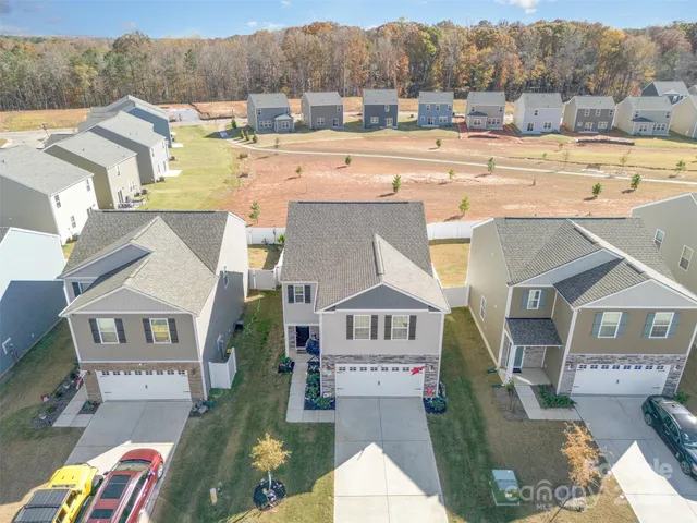 an aerial view of houses with outdoor space