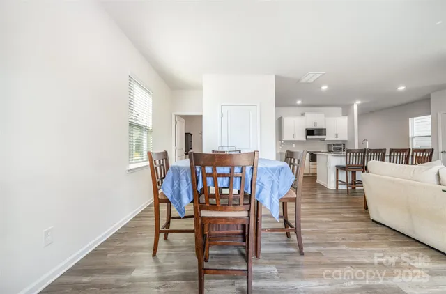 a kitchen with stainless steel appliances granite countertop a white cabinets and wooden floor