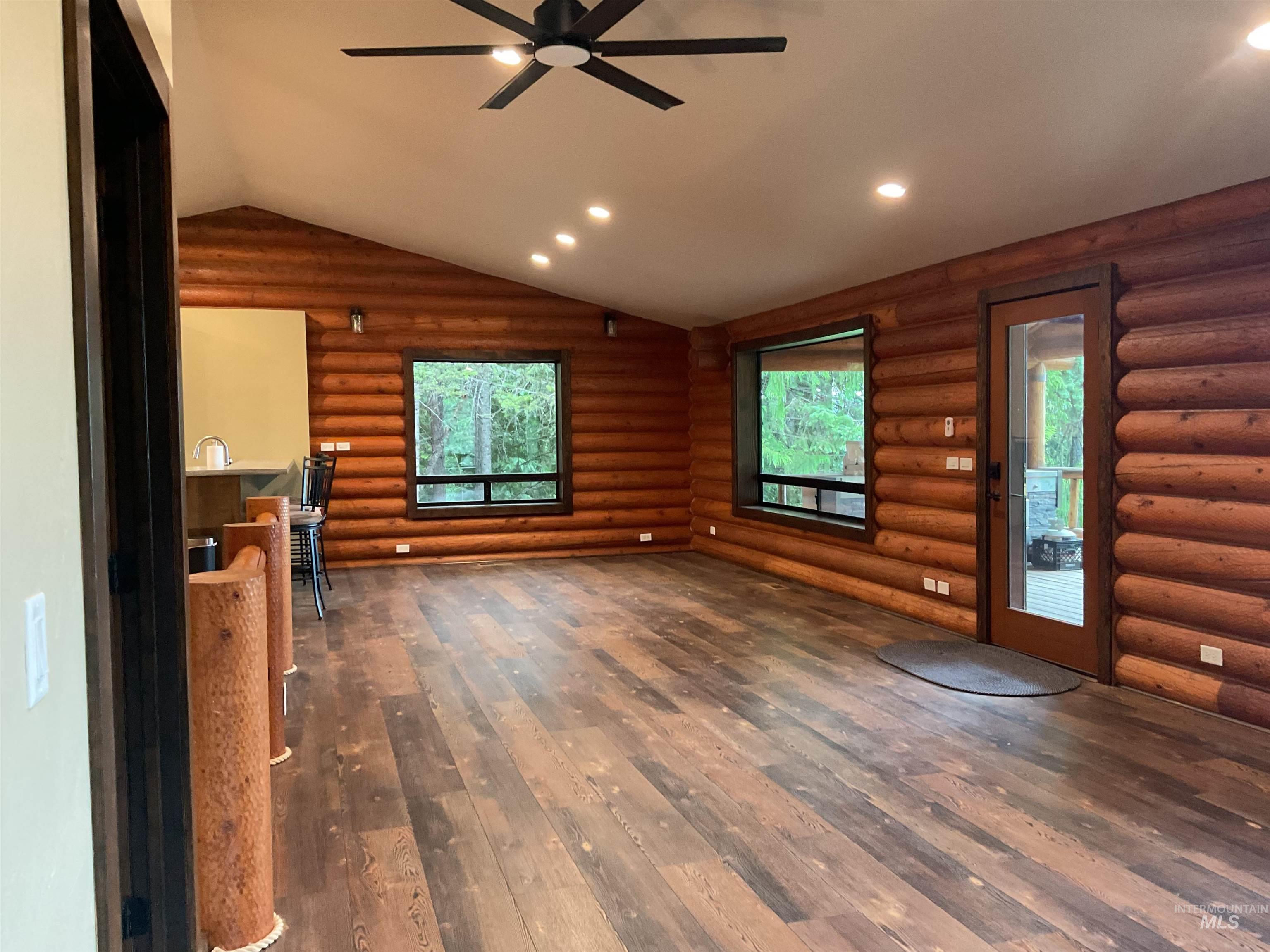 6125 Freeman Creek Road Lenore, ID 83541 - Photo 12 of 44 Spacious room featuring log walls, wood-finish flooring, and a vaulted ceiling with recessed lighting