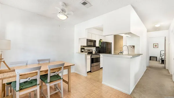 a kitchen with cabinets and stainless steel appliances