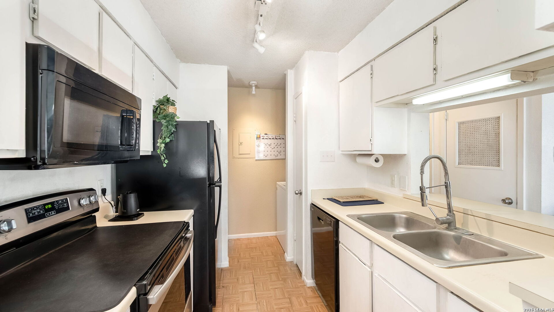 14343 Judson Road, Unit 1201 San Antonio, TX 78233 - Photo 4 of 11 a kitchen with a sink stainless steel appliances and counter space