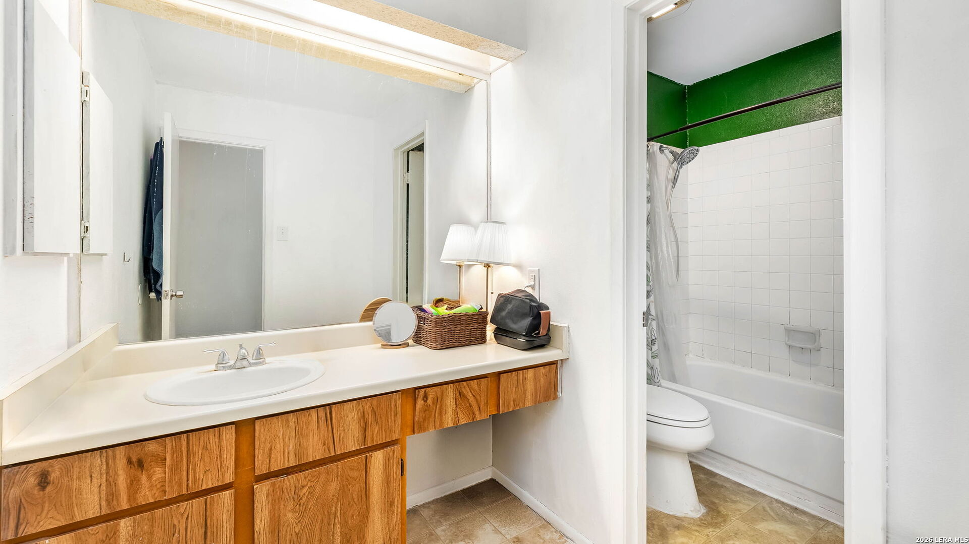 14343 Judson Road, Unit 1201 San Antonio, TX 78233 - Photo 7 of 11 a bathroom with a granite countertop sink toilet and shower