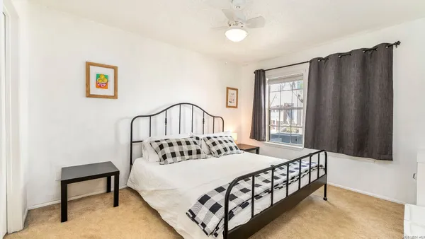 a bedroom with a bed a table and chair