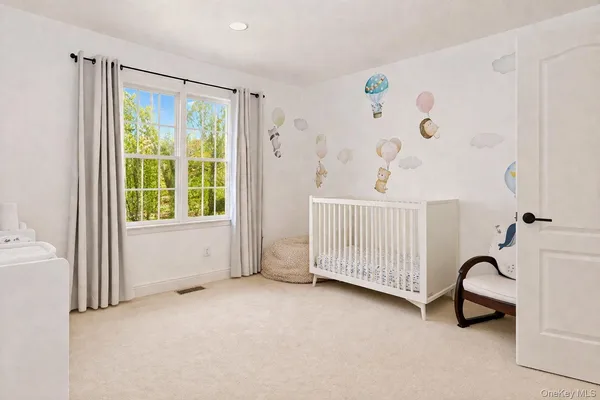 a spacious bedroom with a bed and a window