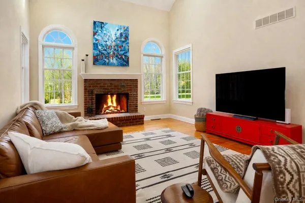 a living room with furniture kitchen view and large windows