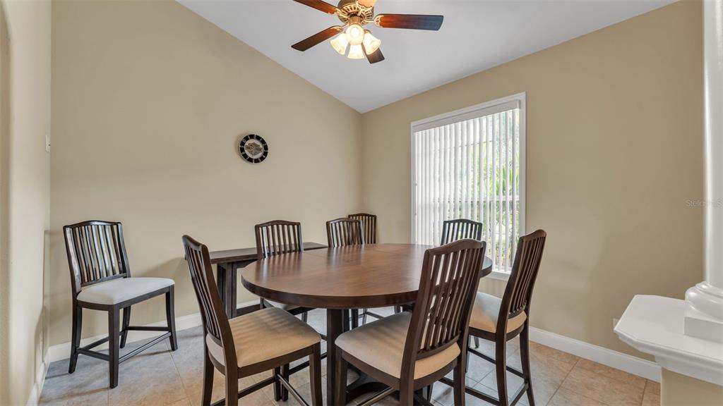 730 Country Walk Cove Eagle Lake, FL 33839 - Photo 11 of 38 a view of a dining room with furniture and window