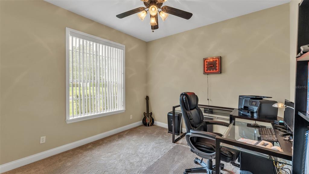 730 Country Walk Cove Eagle Lake, FL 33839 - Photo 13 of 38 a view of a workspace with furniture and a window