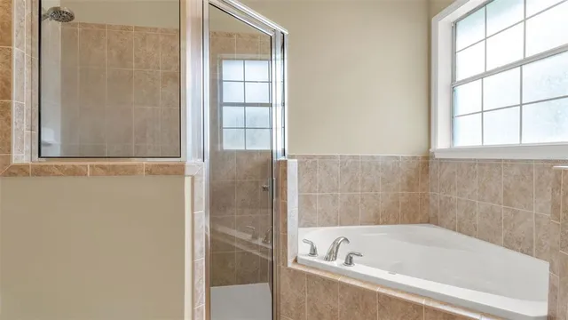 a bathroom with a bathtub and window