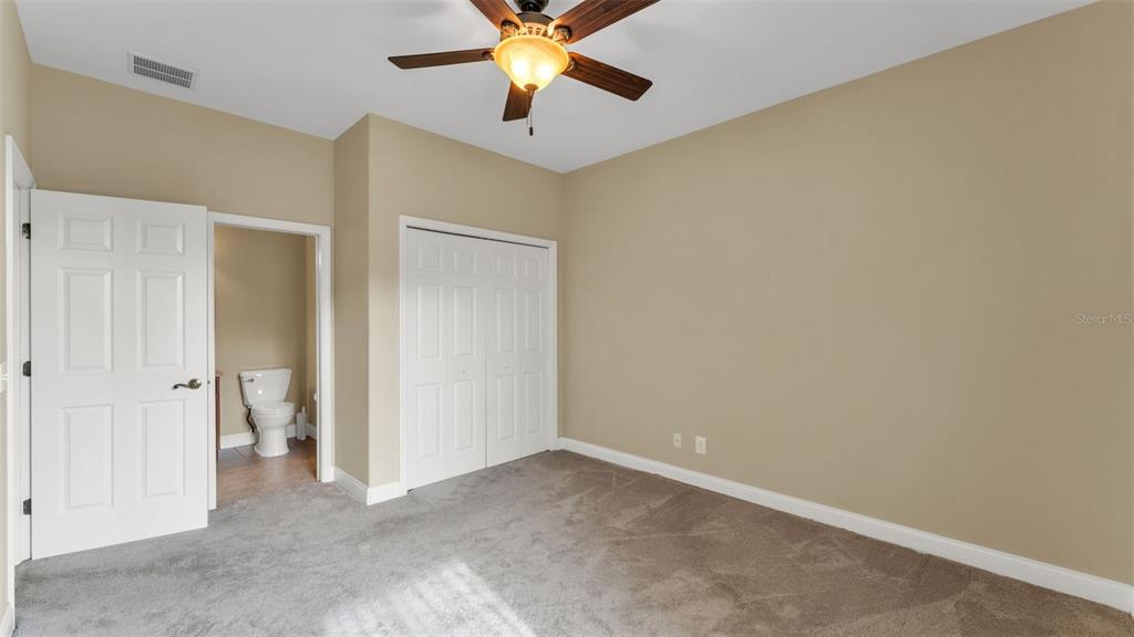 730 Country Walk Cove Eagle Lake, FL 33839 - Photo 24 of 38 an empty room with closet and a chandelier fan