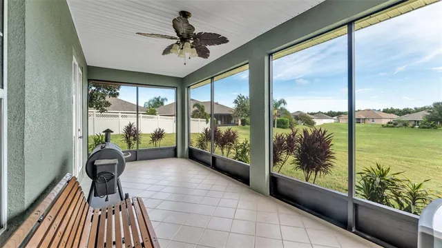 a view of a porch with furniture and floor to ceiling window