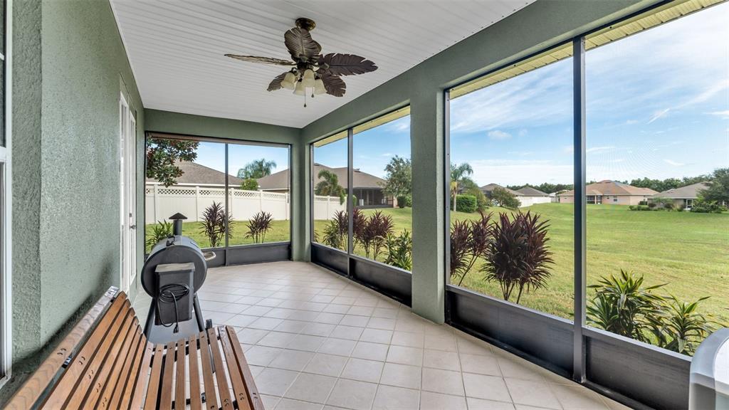 730 Country Walk Cove Eagle Lake, FL 33839 - Photo 29 of 38 a view of a porch with furniture and floor to ceiling window