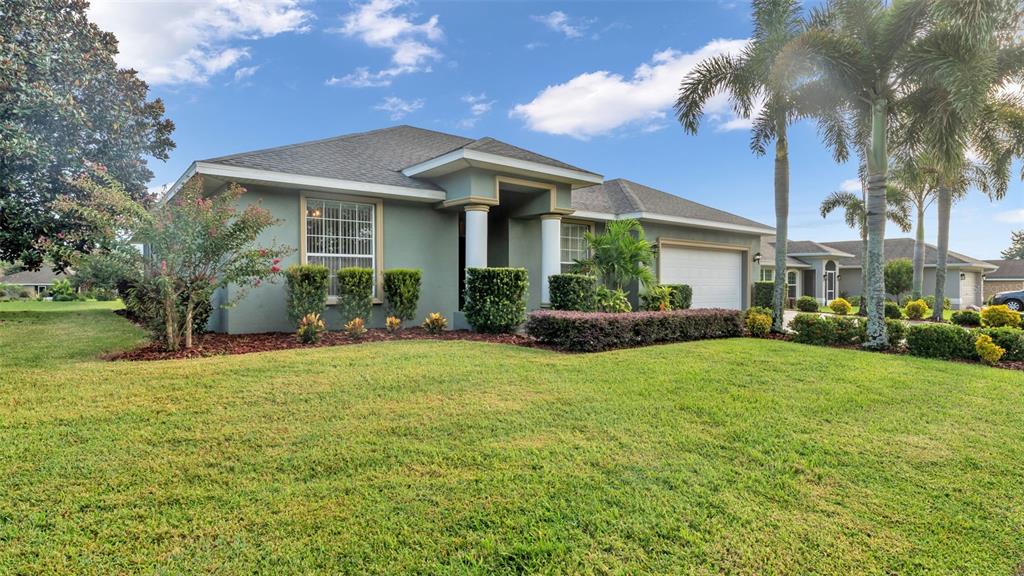 730 Country Walk Cove Eagle Lake, FL 33839 - Photo 32 of 38 a front view of a house with garden