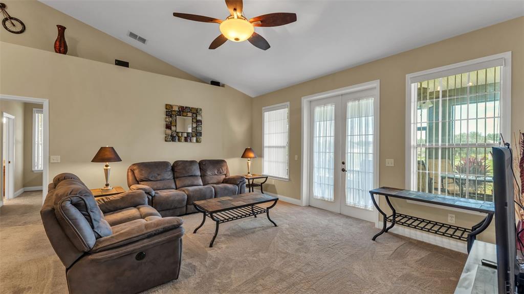 730 Country Walk Cove Eagle Lake, FL 33839 - Photo 4 of 38 a living room with furniture and a large window