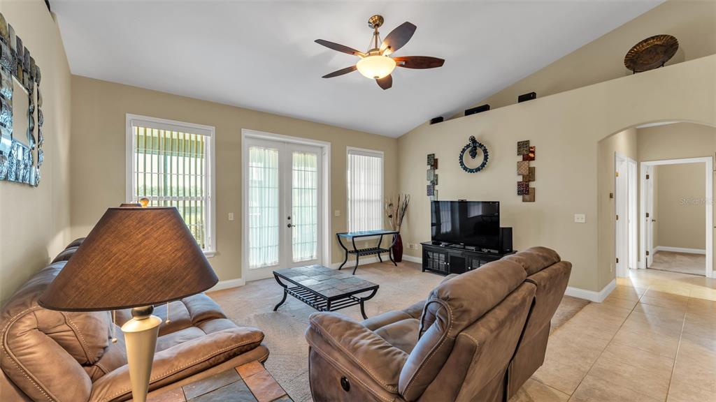 730 Country Walk Cove Eagle Lake, FL 33839 - Photo 5 of 38 a living room with furniture ceiling fan and a rug