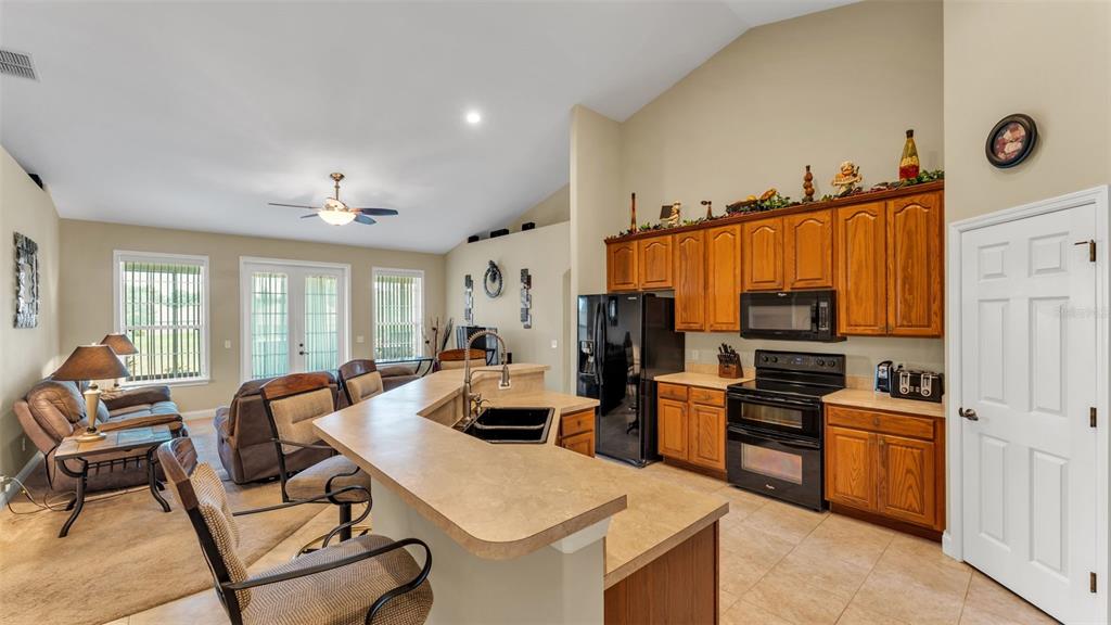 730 Country Walk Cove Eagle Lake, FL 33839 - Photo 7 of 38 a view of kitchen with sink refrigerator and microwave