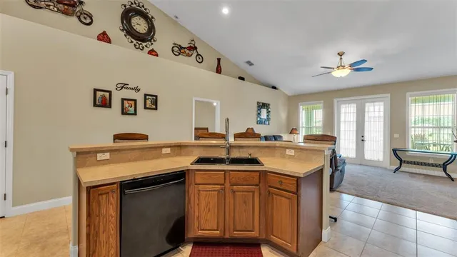 a kitchen with a sink a stove and chairs
