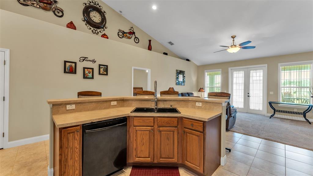 730 Country Walk Cove Eagle Lake, FL 33839 - Photo 9 of 38 a kitchen with a sink a stove and chairs