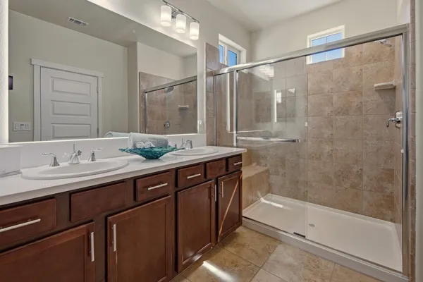 a bathroom with a granite countertop sink and a bathtub