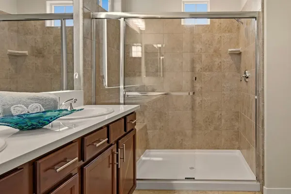 a bathroom with a granite countertop sink and a mirror