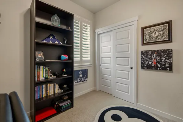 a livingroom with toys and a book shelf