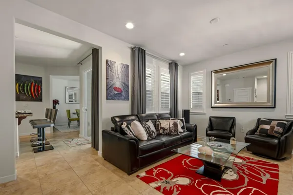 a living room with furniture and a mirror