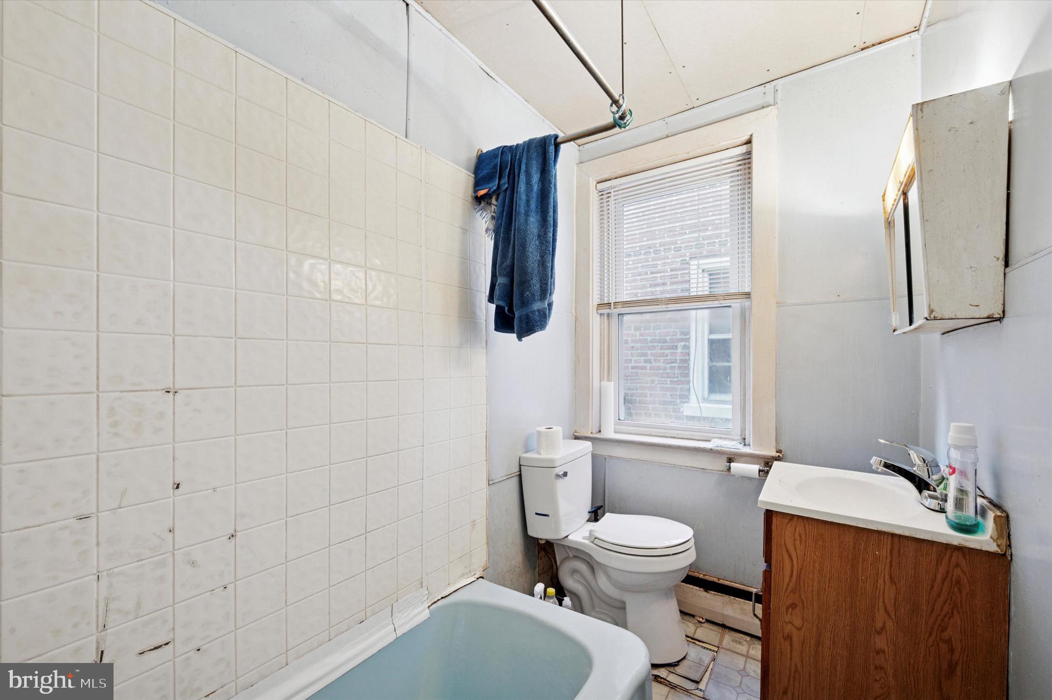 331 North 10th Street Darby, PA 19023 - Photo 5 of 15 a bathroom with a toilet a sink and mirror