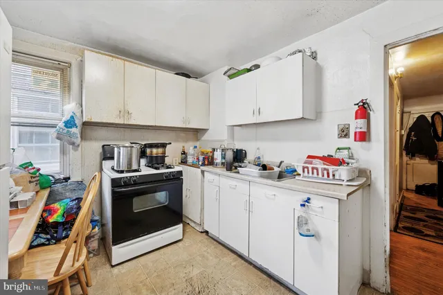 a kitchen with a white stove and white cabinets