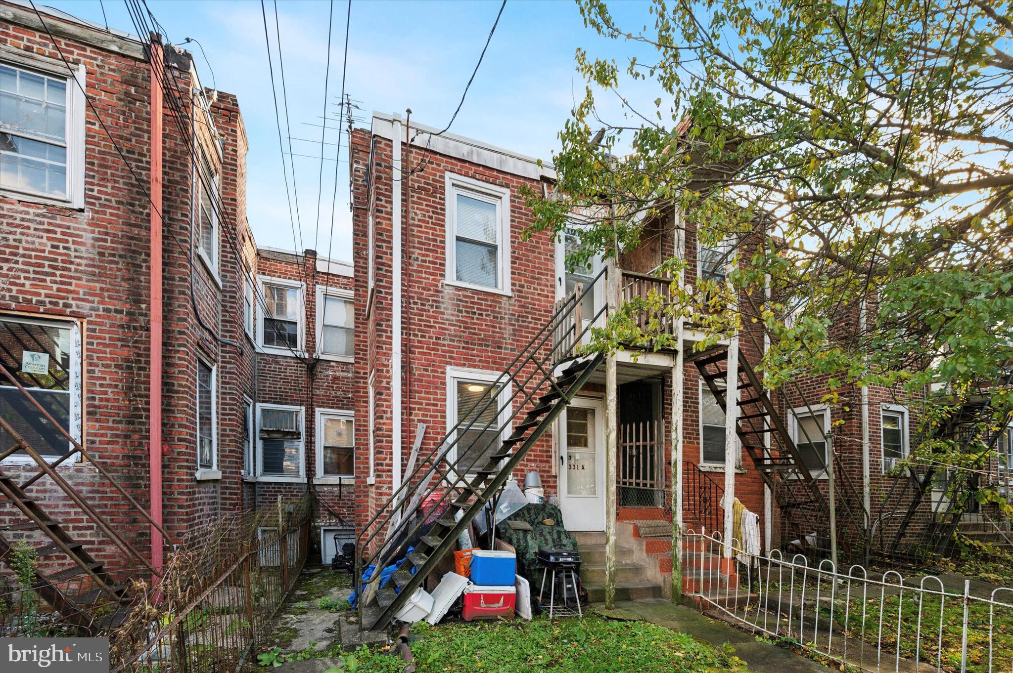 331 North 10th Street Darby, PA 19023 - Photo 9 of 15 a view of a house with a small yard and potted plants