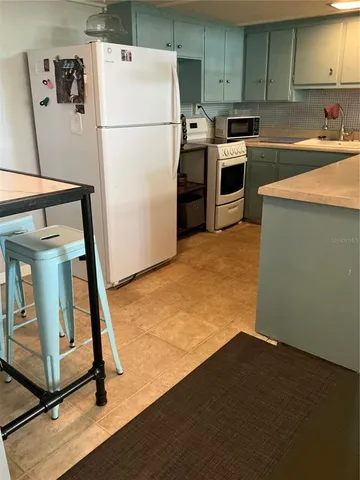 a kitchen with a refrigerator a stove top oven a sink and dishwasher