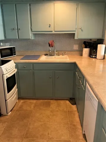 a kitchen with stainless steel appliances a refrigerator sink and cabinets