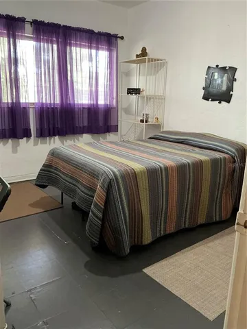 a bedroom with a bed and window