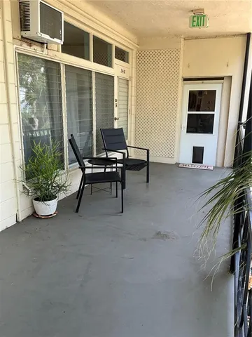 a view of a house with backyard porch and sitting area
