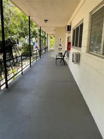 a living room with furniture tv and floor to ceiling window