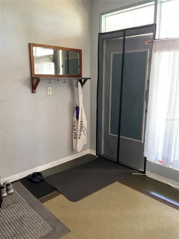 a view of a livingroom with wooden floor and a window